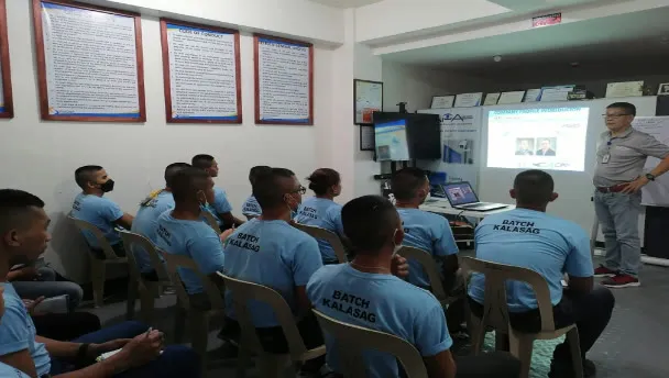 An instructor presenting to a class of security personnel